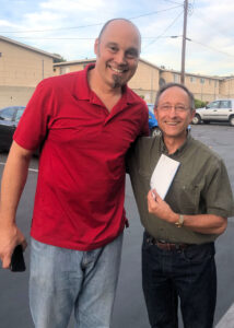 IT Supervisor Chris Allen presents a check for $500 to Shepherd's Pantry Executive Director Craig Cerro