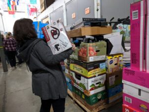 Volunteer filling up a pallet of goods at Giving Children Hope
