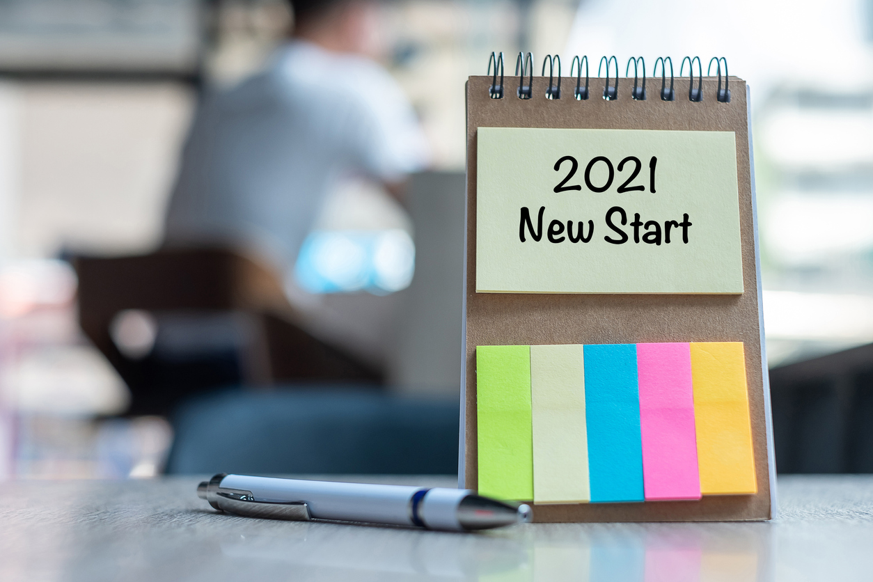 2021 new start word on note paper with pen on wooden table. resolution, strategy, solution, goal, business, new year new you and happy holiday concepts