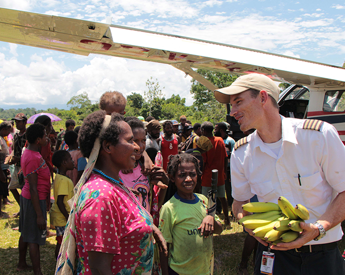 MAF Pilot Giving Bananas to Remote People