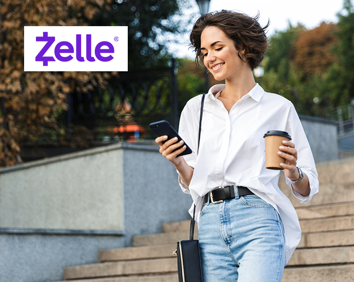 Young Woman with Mobile carrying Coffee using Zelle