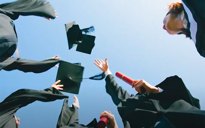 Graduates throwing graduation caps