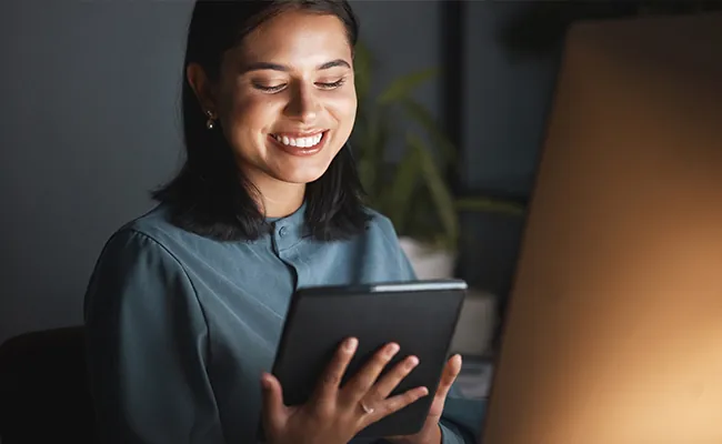 Smiling Woman on Tablet