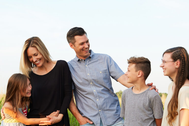 Parents outdoors with 3 children