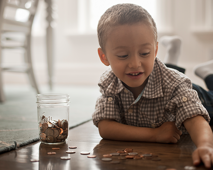 Young boy saving coins